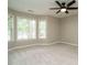 Comfortable bedroom with neutral paint, plush carpet, and natural light from large windows at 102 Ventura Woods Ct, Wake Forest, NC 27587