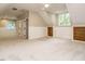 Large bonus room with neutral carpet, natural light, and white wainscoting at 102 Ventura Woods Ct, Wake Forest, NC 27587