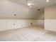 Large bonus room with neutral carpet, ample lighting, and white wainscoting at 102 Ventura Woods Ct, Wake Forest, NC 27587