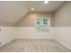 Cozy bonus room with neutral carpet, ample natural light, and white wainscoting at 102 Ventura Woods Ct, Wake Forest, NC 27587