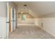 Spacious bonus room with neutral carpet, white wainscoting, ample natural light, and a ceiling fan at 102 Ventura Woods Ct, Wake Forest, NC 27587
