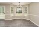Bright dining area with multiple windows and a modern chandelier at 102 Ventura Woods Ct, Wake Forest, NC 27587