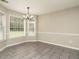 Dining area with a decorative chandelier and big windows at 102 Ventura Woods Ct, Wake Forest, NC 27587