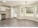 Open dining area with big windows and a modern chandelier at 102 Ventura Woods Ct, Wake Forest, NC 27587