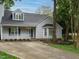 Home with a welcoming front porch and well-manicured landscaping at 102 Ventura Woods Ct, Wake Forest, NC 27587