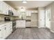 Bright kitchen with stainless appliances, granite counters, white cabinets and tile floors at 102 Ventura Woods Ct, Wake Forest, NC 27587