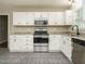 Traditional kitchen featuring stainless steel appliances, white cabinets, and granite countertops at 102 Ventura Woods Ct, Wake Forest, NC 27587