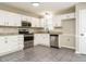 Corner view of kitchen with stainless appliances, granite counters, and white cabinets at 102 Ventura Woods Ct, Wake Forest, NC 27587