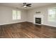 Spacious living room with hardwood floors, a ceiling fan, and a fireplace at 102 Ventura Woods Ct, Wake Forest, NC 27587