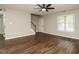 Inviting living room with wood floors, stairs, neutral paint, and a ceiling fan at 102 Ventura Woods Ct, Wake Forest, NC 27587