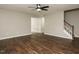 Living room showing the entry to other rooms and stairs. Neutral paint and wood floors at 102 Ventura Woods Ct, Wake Forest, NC 27587
