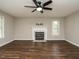 Bright living room featuring a fireplace with a marble hearth and dark hardwood floors at 102 Ventura Woods Ct, Wake Forest, NC 27587