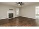 Spacious living room features a fireplace, ceiling fan, and hardwood floors at 102 Ventura Woods Ct, Wake Forest, NC 27587