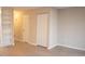 Spacious bedroom with light-colored wood flooring, closet and hallway access, complemented by built-in storage shelves at 106 Weatherstone Dr # B, Chapel Hill, NC 27514