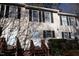 Tan townhouse exterior with dark shutters and matching wooden staircases, front door decorations add a personal touch at 106 Weatherstone Dr # B, Chapel Hill, NC 27514