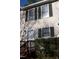 A townhouse with a white door, dark shutters, and a small deck at 106 Weatherstone Dr # B, Chapel Hill, NC 27514