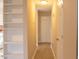 Hallway with light-colored wood flooring, storage shelves, and convenient access to various rooms within the home at 106 Weatherstone Dr # B, Chapel Hill, NC 27514