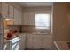 Kitchen with stainless sink, white cabinets, granite countertops, and modern appliances for a stylish cooking experience at 106 Weatherstone Dr # B, Chapel Hill, NC 27514