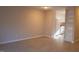 Spacious living room with light wood flooring and neutral paint, next to an open kitchen and built in storage shelves at 106 Weatherstone Dr # B, Chapel Hill, NC 27514