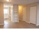 Open-concept space next to kitchen and storage shelves, featuring wood flooring and access to other rooms in the house at 106 Weatherstone Dr # B, Chapel Hill, NC 27514