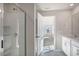 New bathroom featuring a glass shower, a double sink, and a large window at 112 Pisgah St, Sanford, NC 27330