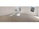 Large bright carpeted bedroom with multiple windows and sunlight at 112 Pisgah St, Sanford, NC 27330