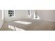 This large bedroom has neutral carpet and multiple windows at 112 Pisgah St, Sanford, NC 27330