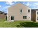 Spacious home featuring neutral siding, well-manicured lawn, and a sliding glass door leading to a patio at 112 Pisgah St, Sanford, NC 27330