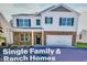 Charming two-story home featuring white siding, a stone facade, green shutters, and an attached two car garage at 112 Pisgah St, Sanford, NC 27330