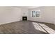 Spacious living room with wood-look floors, a corner fireplace, and plenty of natural light at 112 Pisgah St, Sanford, NC 27330