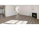 Open-concept living area with wood-look floors, fireplace, and staircase at 112 Pisgah St, Sanford, NC 27330