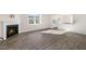 Living room with wood-look floors, fireplace, and an open view into the adjacent kitchen at 112 Pisgah St, Sanford, NC 27330