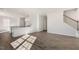 Open living area with wood floors and staircase. Kitchen area is visible beyond the divider at 112 Pisgah St, Sanford, NC 27330