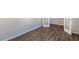 Bright room with wood-look floors and white trim, featuring double glass doors for added light at 112 Pisgah St, Sanford, NC 27330