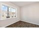 Bright, empty room with wood-look floors, a large window, and neutral paint, ready for customization at 112 Pisgah St, Sanford, NC 27330