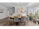 Well-lit dining room features modern lighting, hardwood floors, and neutral paint at 1201 Opeushaw Ct, Wake Forest, NC 27587