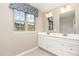 Bathroom with a double vanity, framed mirrors, and natural light at 121 Mason Oaks Dr, Wake Forest, NC 27587