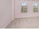 Bright bedroom with carpeted floor, two windows, and light pink paint at 121 Mason Oaks Dr, Wake Forest, NC 27587
