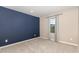 Bedroom featuring a dark blue accent wall, carpeted floor, and natural light at 121 Mason Oaks Dr, Wake Forest, NC 27587