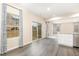Bright dining area with modern flooring, large windows with curtains, connecting to a functional kitchen with an island at 121 Mason Oaks Dr, Wake Forest, NC 27587
