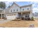 Charming two-story home featuring a two-car garage and covered front porch at 121 Mason Oaks Dr, Wake Forest, NC 27587