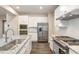 This kitchen features stainless steel appliances, granite countertops, and white cabinets at 121 Mason Oaks Dr, Wake Forest, NC 27587