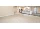 Open-concept living area seamlessly flowing into a modern kitchen with white cabinets and stainless steel appliances at 121 Mason Oaks Dr, Wake Forest, NC 27587