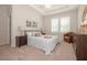 Bright bedroom featuring tray ceilings, neutral walls, plush carpet, and light blue bed linens at 129 Rolesville Ridge Dr, Rolesville, NC 27571