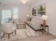 Comfortable living room showcasing stylish decor, a large rug, and ample natural light, creating a cozy atmosphere at 129 Rolesville Ridge Dr, Rolesville, NC 27571