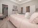 Serene main bedroom with a tray ceiling, soft lighting, neutral decor, and a glimpse of a spacious walk-in closet at 129 Rolesville Ridge Dr, Rolesville, NC 27571