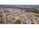 This is an aerial image showing a community with modern homes, well-kept lawns, and a pool at 1530 Armscroft Ln, Apex, NC 27502