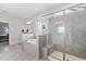 Modern bathroom showcasing a glass enclosed shower, soaking tub, and large tile flooring at 1530 Armscroft Ln, Apex, NC 27502