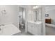 Bright bathroom showcasing a white vanity and a connecting half bathroom at 1530 Armscroft Ln, Apex, NC 27502