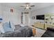Cozy bedroom featuring neutral walls, ceiling fan, and a comfortable bed, promoting relaxation at 1530 Armscroft Ln, Apex, NC 27502